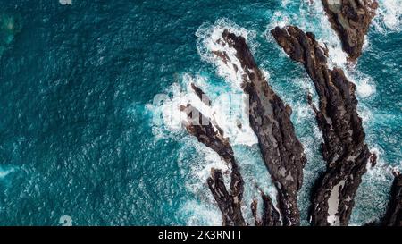 Atlantic ocean coastline with cliffs rocks and turquoise waves. Madeira island, Portugal. Drone photography. Sea background. Stock Photo