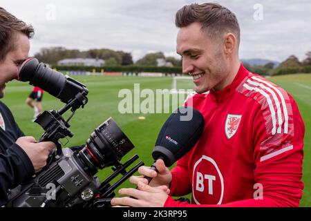 PONTYCLUN, WALES - 19 SEPTEMBER 2022: Wales' Connor Roberts and FAW TV Videographer Nathan Williamsduring a training session at the vale resort ahead Stock Photo