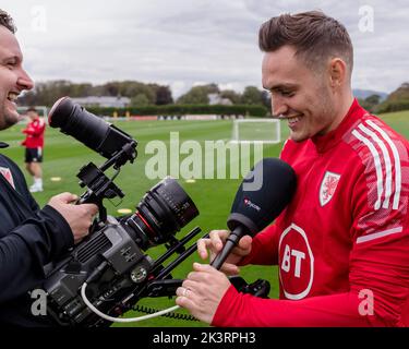 PONTYCLUN, WALES - 19 SEPTEMBER 2022: Wales' Connor Roberts and FAW TV Videographer Nathan Williamsduring a training session at the vale resort ahead Stock Photo