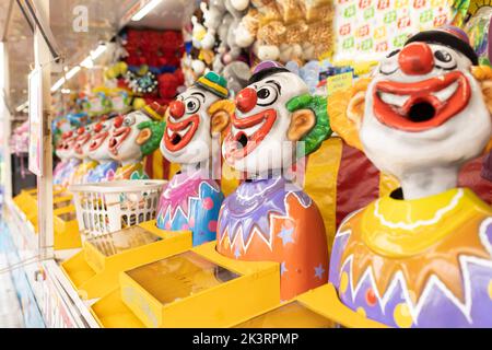 Laughing clowns game attraction at a fair carnival Stock Photo