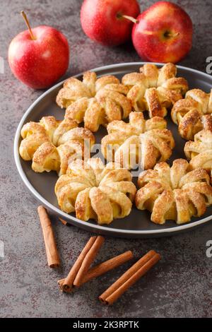 Autumn apples baked in dough close-up on a plate on the table. Vertical Stock Photo