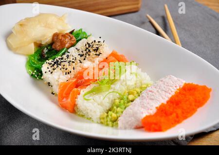beautiful layered tasty poke with salmon on a white plate Stock Photo