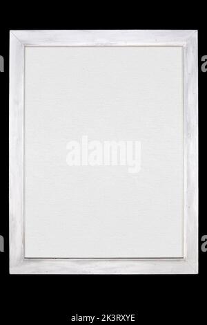 White wooden painted frame with white blank canvas isolated on black background Stock Photo