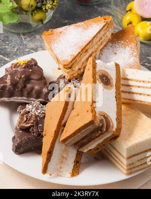 tasty assorted sweets on a plate: souffle cakes and brownies with chocolate and nuts Stock Photo