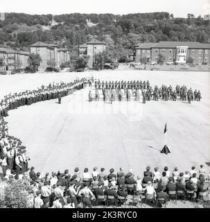 1964, historical, an overhead view of the parade ground at RAF Halton, Bucks, England, UK, where spectators are watching a formal graduation ceremony take place. RAF Halton was the home of the No 1 School of Technical Training, the Royal Air Force's aircraft engineering school from 1919 to 1993. Stock Photo