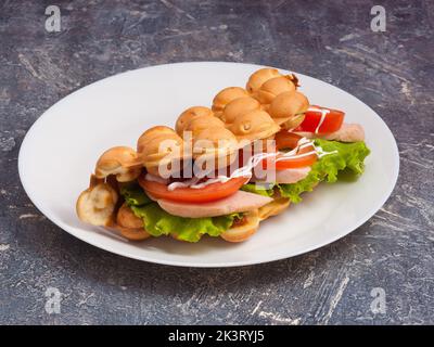 tasty Hong Kong waffle with ham and fresh vegetables Stock Photo