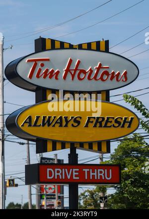 Tim Hortons sign and drive-thru at restaurant front. Canada's quick serve restaurant chain nicknamed Tim's . Halifax, Nova Scotia, Canada - SEP 2022 Stock Photo