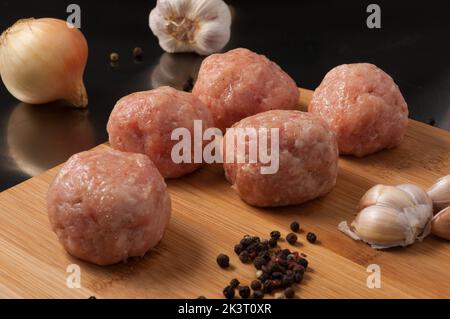 raw meatballs chicken on wooden Board Stock Photo
