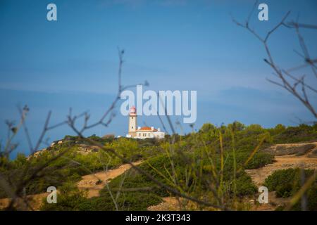 Carvoeiro, Portugal, September 2022: View on Alfanzina lighthouse from a distance on the seven hanging valley hikes along the Algarve coast in Portuga Stock Photo