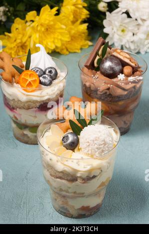 sweet desserts in plastic cups with cream and chocolate Stock Photo