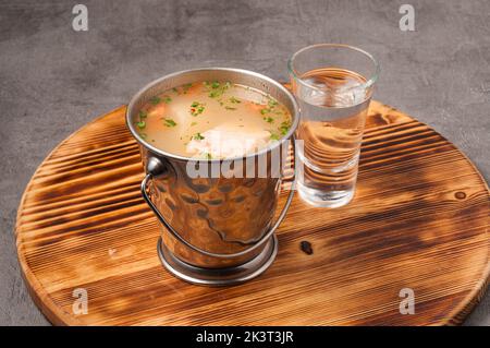 tasty traditional Russian fish soup with salmon pike perch and vodka Stock Photo