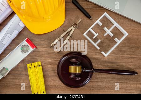 Construction and Labor law flat lay. Judge gavel and design tools on wooden table, top view. Stock Photo