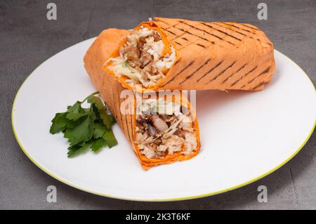 tasty shawarma or doner kebab with chicken on a white plate Stock Photo