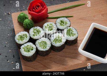 tasty rolls with cucumber in nori seaweed and soy sauce Stock Photo