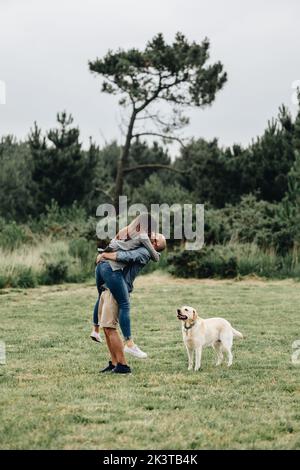 Side view of loving couple playing in the mountain Stock Photo