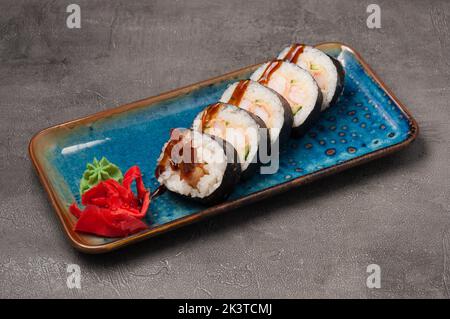tasty sushi rolls with shrimp tempura and cucumber with unagi sauce Stock Photo