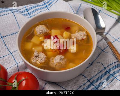tasty soup with potatoes, carrots, onions, bell peppers and meatballs Stock Photo