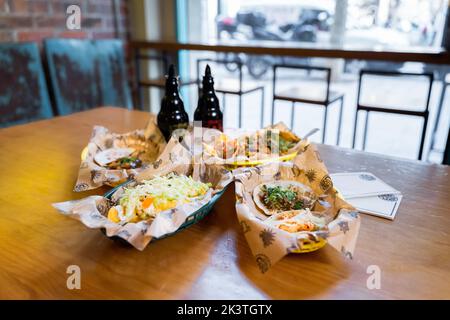 Set of yummy fresh Mexican food served for lunch on wooden table in light restaurant Stock Photo