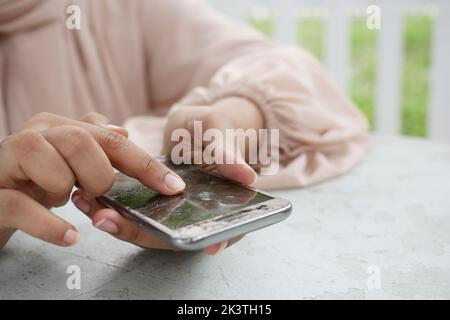women pointing finger on broken smart phone screen  Stock Photo
