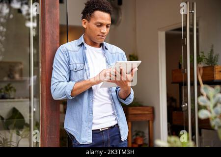 Latin American plant nursery worker using digital tablet Stock Photo
