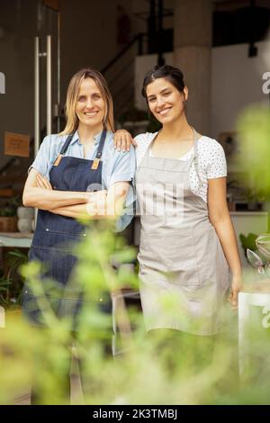 Greenhouse owners looking and smiling at the camera Stock Photo