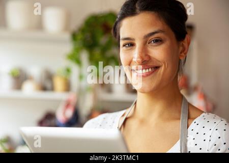 Young adult female entrepreneur smiling at the camera Stock Photo