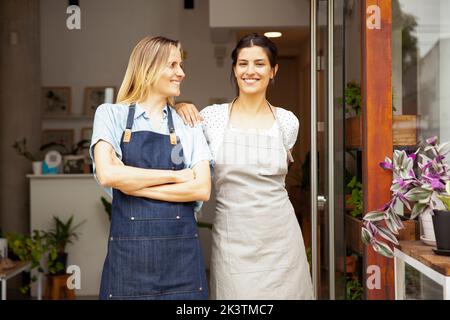 Small business flower shop owners standing with arms crossed Stock Photo