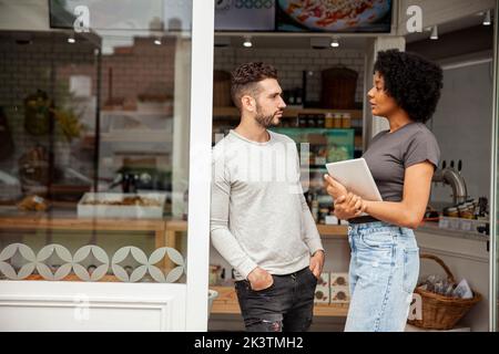 African American bakery owner standing with colleague Stock Photo