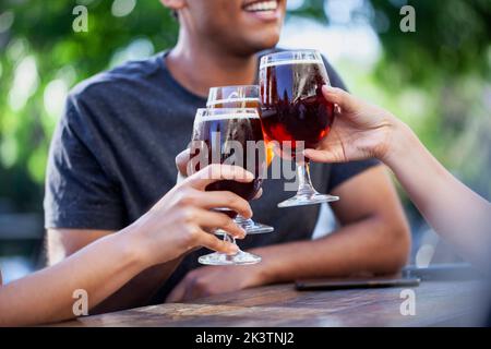 Mid section view of three friends toasting with beers Stock Photo