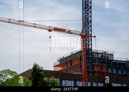 Large cranes for construction of an apartment building Stock Photo