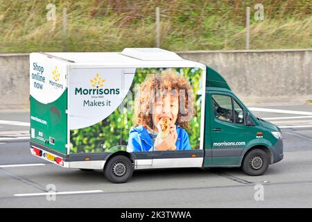 Morrisons supermarket internet food grocery supply chain side of colourful delivery van home supply service to online food shopping customers Essex UK Stock Photo