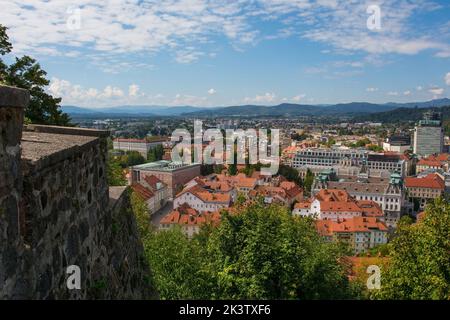 The city of Ljubljana in central Slovenia viewed from the historic castle on Castle Hill. Part of the castle walls can be seen on the left Stock Photo