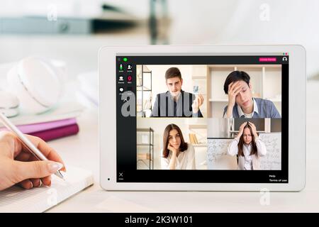 Virtual meeting. Video conference. Corporate webinar. Covid-19 WFH. Diverse multiracial business team brainstorming working on project online on table Stock Photo