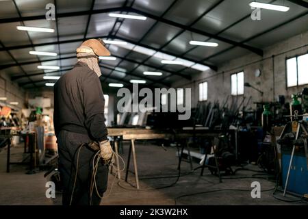 Male welder working hard in workshop Stock Photo