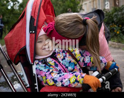 Izyum, Ukraine. 19th Sep, 2022. Diana, 9 was seen giving her sister Aliza, 2 a kiss on the cheek. The sisters stayed under Russian occupation for 5 months. Ukrainian troops liberated Izyum and other key strategic areas in Kharkiv region three weeks ago. Residents slowly returning to normality despite signs of Russian occupants still in the city and the city remains out of water, electricity and gas. (Credit Image: © Ashley Chan/SOPA Images via ZUMA Press Wire) Stock Photo