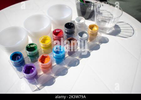 12 color jars on the sunlight ready for painting and mixing Stock Photo