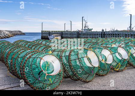 Fishing traps stacked on the pier. Ste-Anne-des-Monts, Gaspesia, Quebec, Canada. Commercial fishing dock. Stock Photo