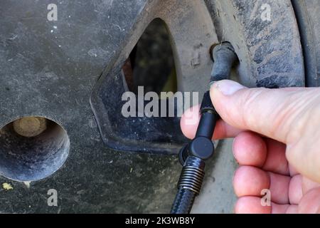 Car service. Checking wheel pressure. Vehicle maintenance. Stock Photo