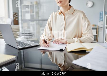 Minimal closeup of businesswoman taking notes in meeting or job interview, copy space Stock Photo