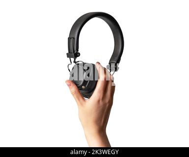 Black headphones in hand isolated on white. High quality photo Stock Photo