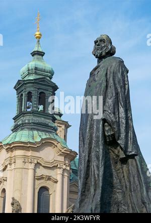 Prague Czech Republic September 25, 2022, Prague photo series: Jan Hus Monument in Old Town Square in Prague with St. Nicholas Church in the backgroun Stock Photo