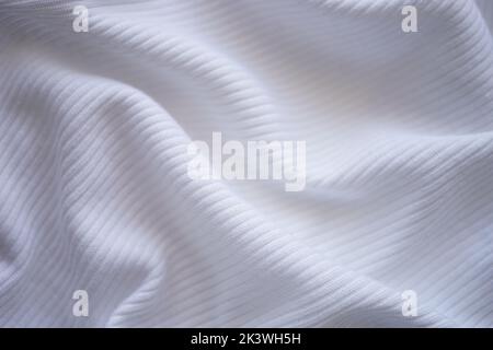 wrinkled white jersey, soft fabric background. Stock Photo