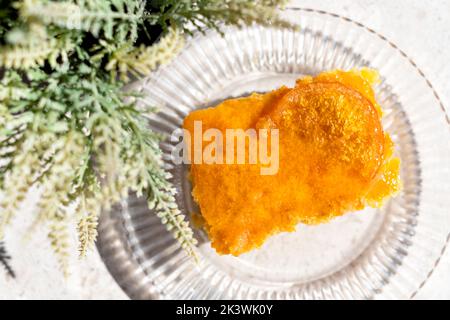 A serving or slice of Orange Pie. This is a Greek speciality known as Portokalopita. Its made with phyllo pastry and soaked in an orange syrup Stock Photo