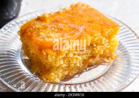 A serving or slice of Orange Pie. This is a Greek speciality known as Portokalopita. Its made with phyllo pastry and soaked in an orange syrup Stock Photo
