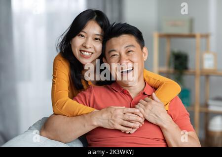 Portrait of cheerful asian couple posing at home Stock Photo