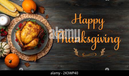 Thanksgiving Greetings. Roasted chicken or turkey for festive dinner on wooden table. Thanksgiving Day concept Stock Photo