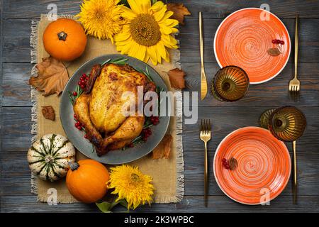 Happy Thanksgiving holiday background. Roasted chicken or turkey, pumpkins for Thanksgiving dinner. Festive table settings for Thanksgiving Day. Copy Stock Photo