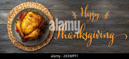 Thanksgiving Greetings. Roasted chicken or turkey for festive dinner on wooden table. Thanksgiving Day concept Stock Photo