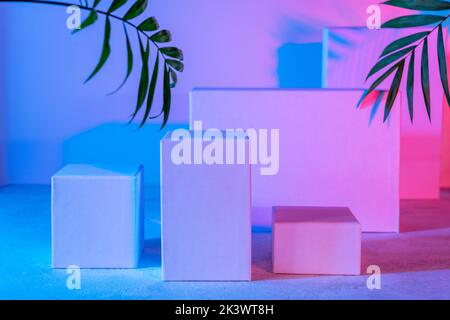 Scene with geometrical forms in neon light. Geometrical podium, pedestal empty stands. Background for cosmetic products. Showcase, product presentatio Stock Photo