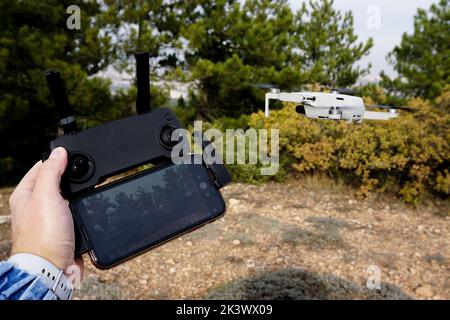 A female controlling a drone Stock Photo